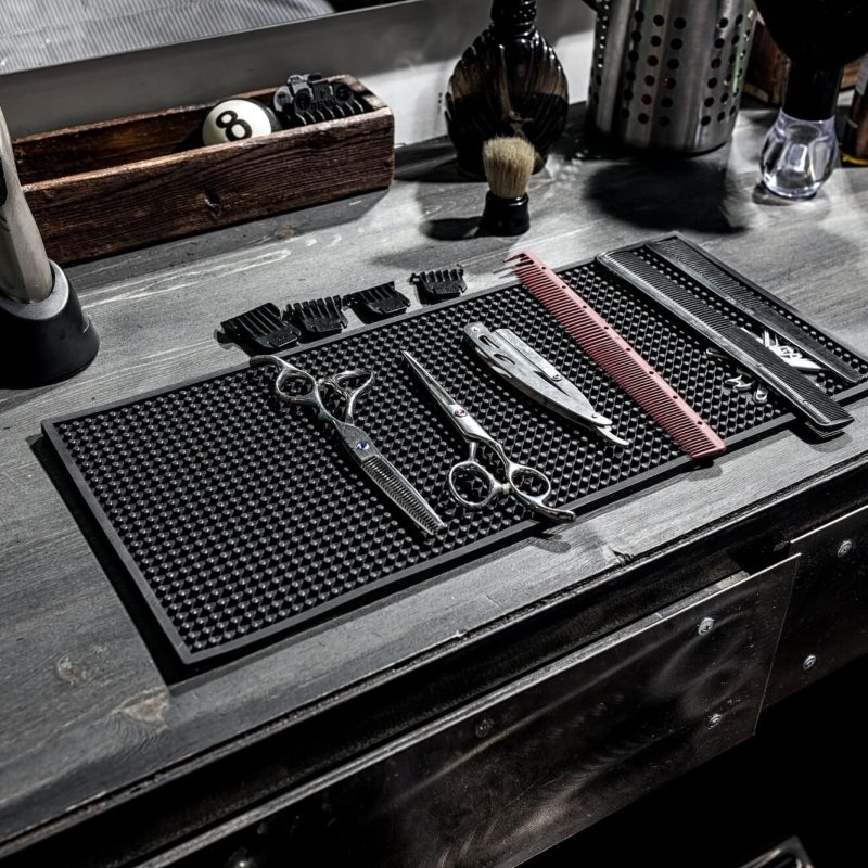 the-tools-of-the-barber-lie-on-a-black-mat-on-the-desktop.jpg